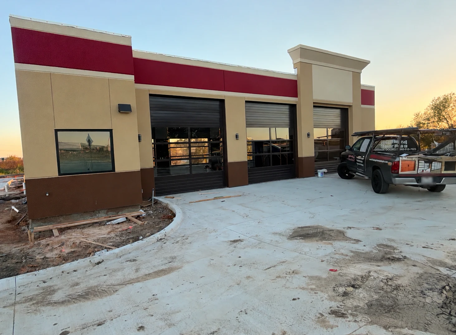 Black and glass commercial overhead doors installed at an automotive service building, from Overhead Door Pros’ project gallery